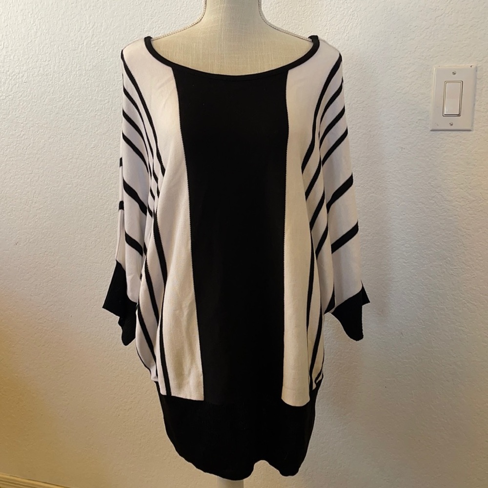 Knit hat above brand. Woman’s Black and white striped size 3X sweater.